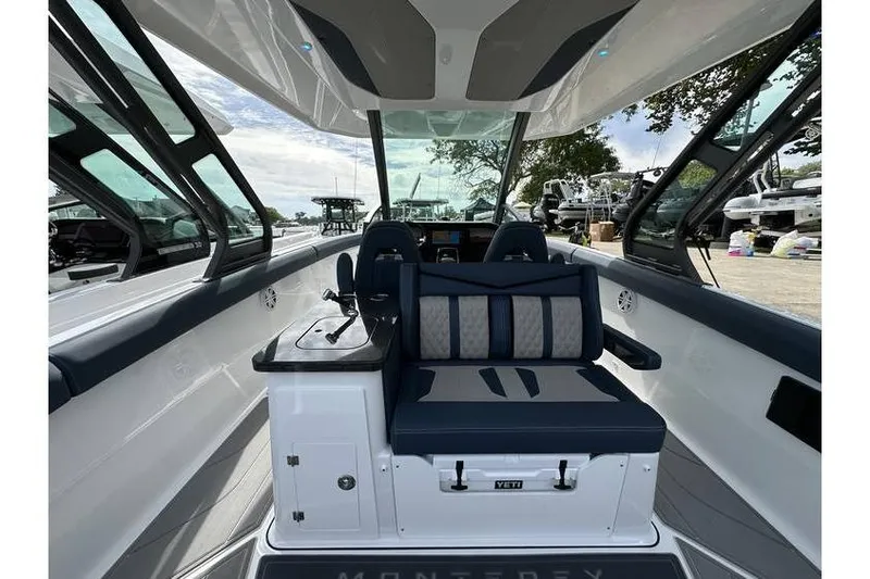 Slide: The Image of 2026 Monterey Elite 30 OB boat interior with modern seating and sleek design. - 2