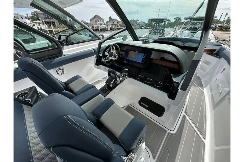 Slide: The Image of 2026 Monterey Elite 30 OB boat interior with modern dashboard and luxurious seating. - 4