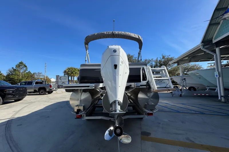 Slide: The Image of 2026 Bennington 24 MFB pontoon boat on trailer, rear view, sunny day. - 14