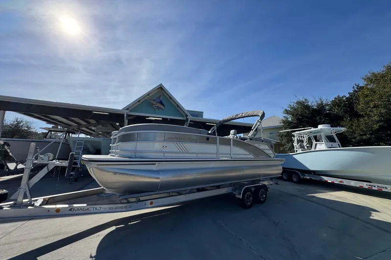 Slide: The Image of 2026 Bennington 24 MFB pontoon boat on trailer under sunny sky. - 3