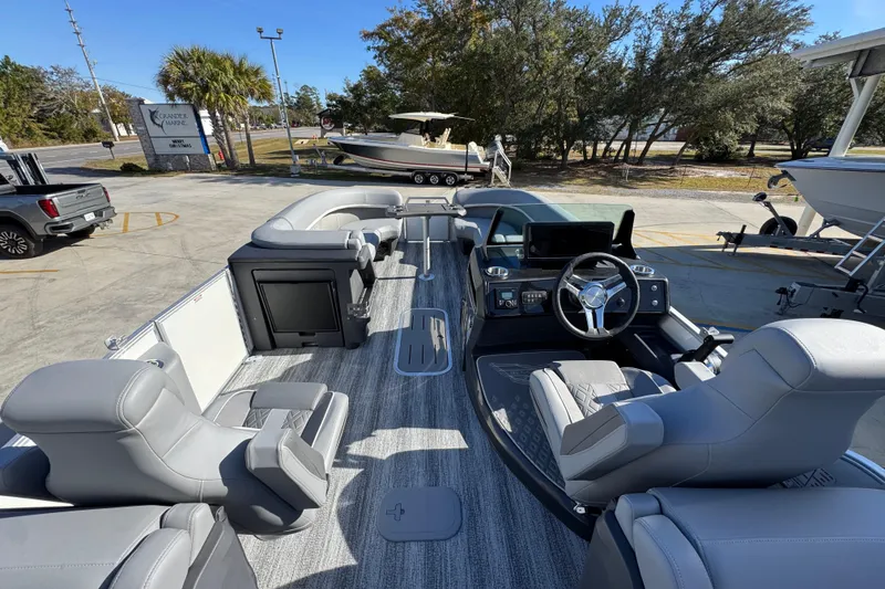Slide: The Image of 2026 Bennington 24 MFB pontoon boat with luxurious seating and modern dashboard. - 30