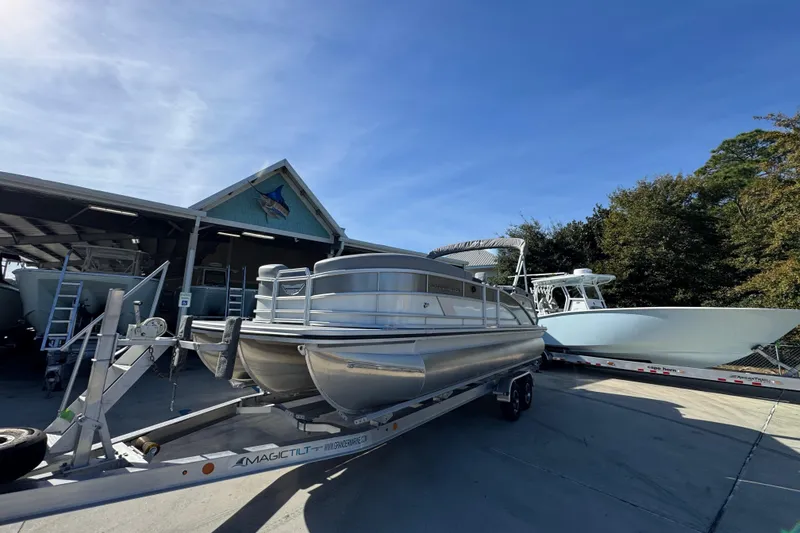 Slide: The Image of 2026 Bennington 24 MFB pontoon boat on trailer at marina. - 4