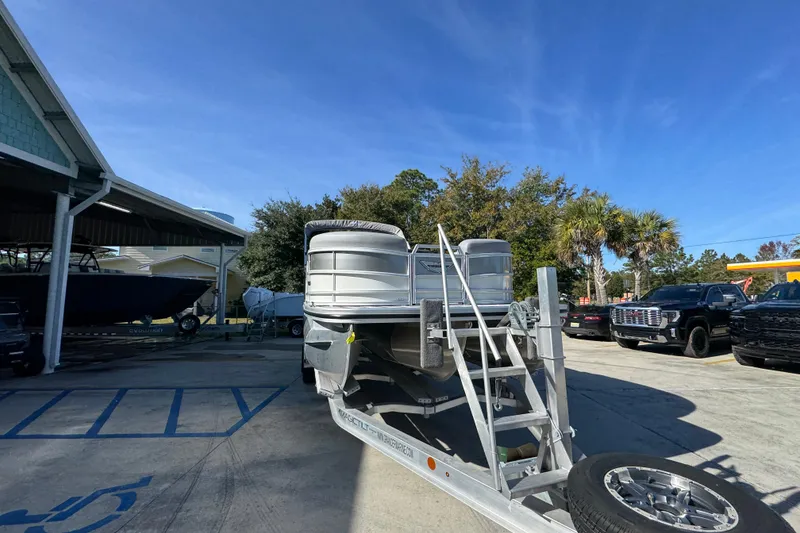 Slide: The Image of 2026 Bennington 24 MFB pontoon boat on trailer in sunny outdoor setting. - 7