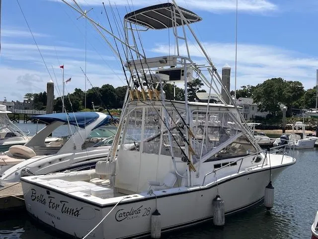 The Image of 2001 Carolina Classic 28 fishing boat docked at a marina. - 0