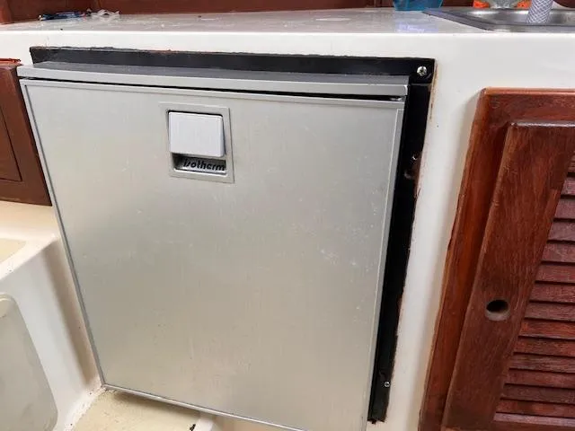 Slide: The Image of Built-in refrigerator on a 2001 Carolina Classic 28 boat. - 12