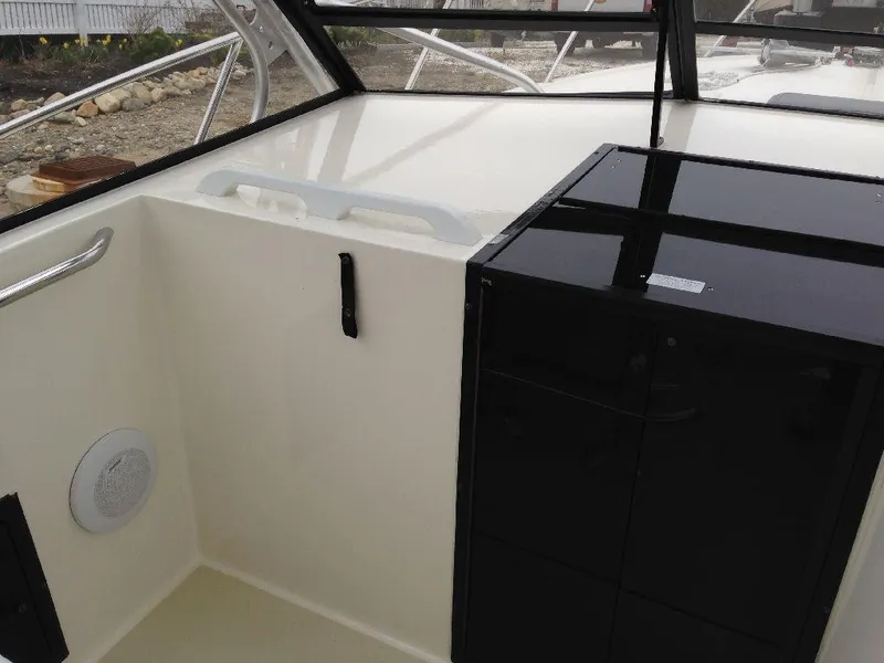 Slide: The Image of Interior view of a 2001 Carolina Classic 28 boat with black cabinetry. - 3