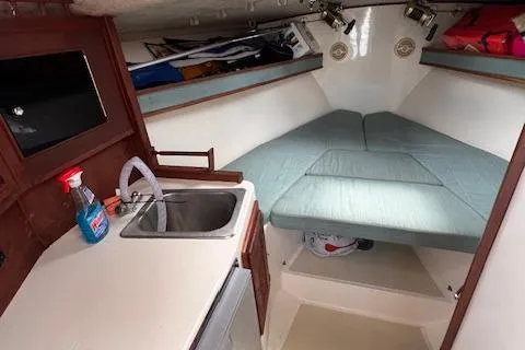 Slide: The Image of 2001 Carolina Classic 28 boat interior with kitchenette and sleeping area. - 8