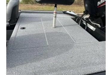 Slide: The Image of 2021 Bass Tracker Classic boat deck with motor, featuring a spacious, carpeted surface. - 12