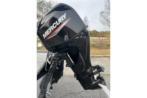 Slide: The Image of 2021 Bass Tracker Classic with Mercury outboard motor in a parking lot. - 13