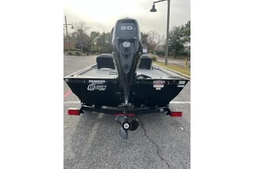 Slide: The Image of 2021 Bass Tracker Classic boat with 50 HP engine, parked outdoors. - 14
