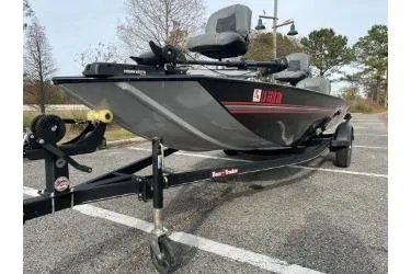 Slide: The Image of 2021 Bass Tracker Classic fishing boat on trailer in parking lot. - 3