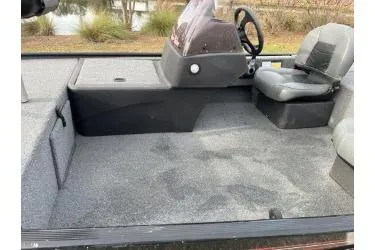 Slide: The Image of 2021 Bass Tracker Classic boat interior with steering console and seating. - 7