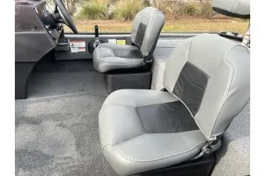 Slide: The Image of 2021 Bass Tracker Classic boat interior with gray seating and steering console. - 8