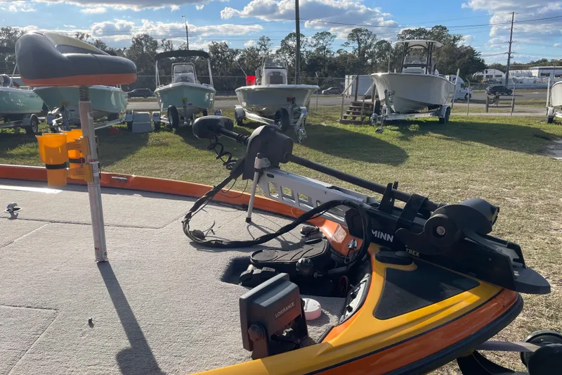 Slide: The Image of 2008 Nitro Z-7 boat with Minn Kota trolling motor and fishing seat, parked outdoors. - 12