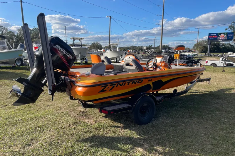 Slide: The Image of 2008 Nitro Z-7 boat with Mercury engine on grassy area under blue sky. - 3