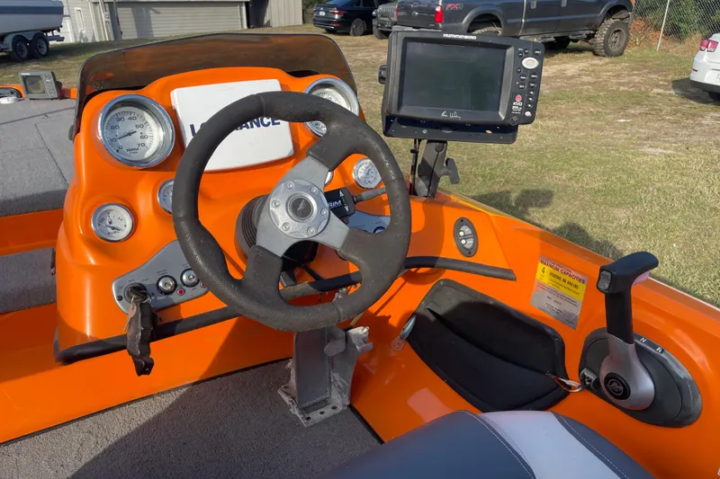 Slide: The Image of 2008 Nitro Z-7 boat dashboard with steering wheel, gauges, and navigation system. - 6