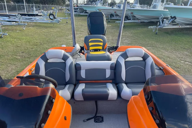 Slide: The Image of 2008 Nitro Z-7 boat interior with orange and gray seating, parked on grass. - 7