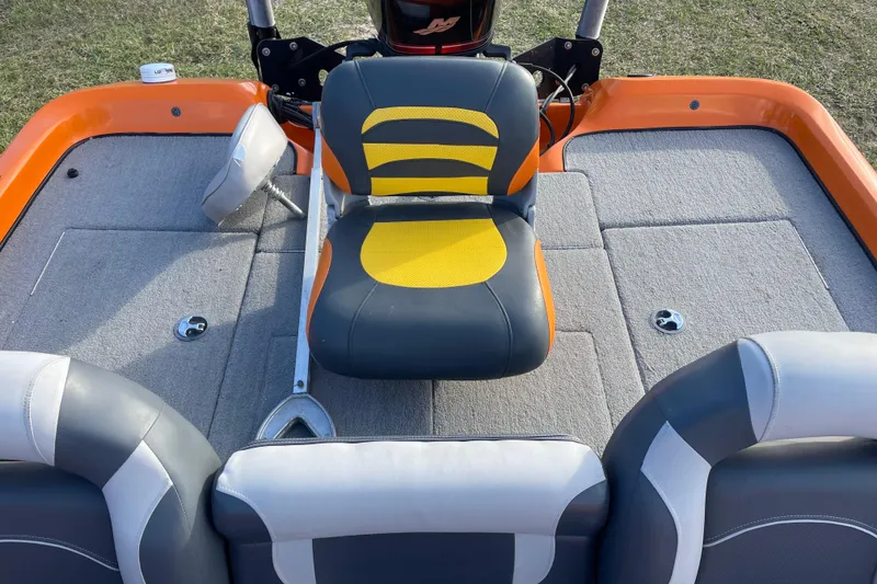 Slide: The Image of 2008 Nitro Z-7 boat interior with orange and gray seating on a carpeted deck. - 8