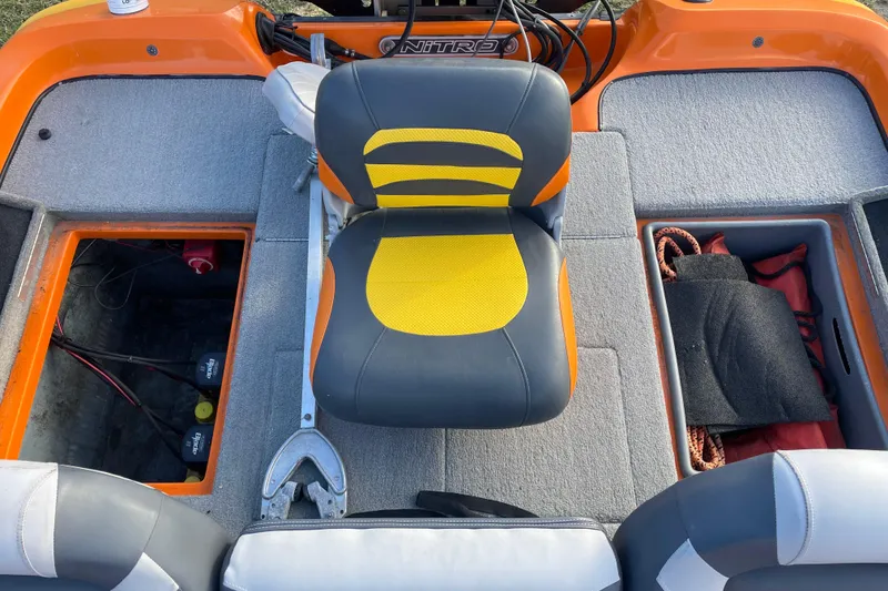 Slide: The Image of 2008 Nitro Z-7 boat interior with orange and yellow seating, storage compartments, and visible battery. - 9