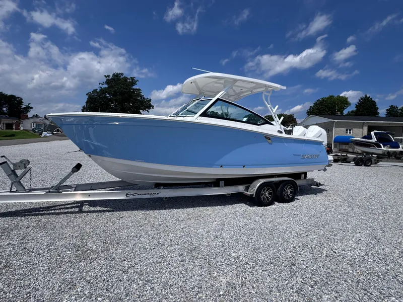 The Image of 2026 Blackfin 272 DC boat on trailer under blue sky. - 0