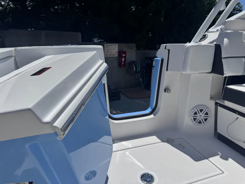 Slide: The Image of 2026 Blackfin 272 DC boat interior with open door and seating area. - 13