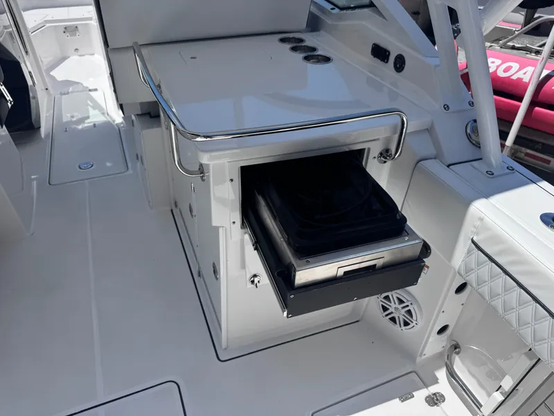 Slide: The Image of 2026 Blackfin 272 DC boat interior with open storage compartment and sleek design. - 16