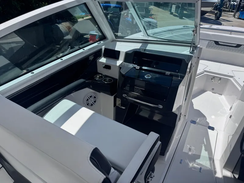 Slide: The Image of 2026 Blackfin 272 DC boat interior with sleek seating and modern dashboard design. - 18