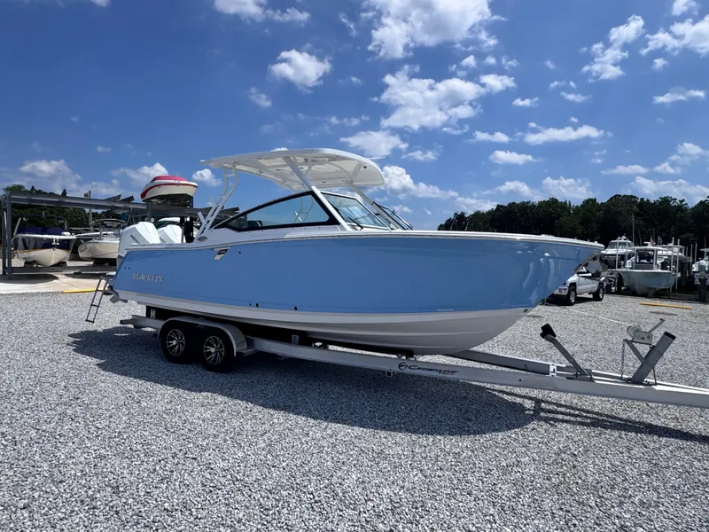 Slide: The Image of 2026 Blackfin 272 DC boat on trailer under blue sky. - 6