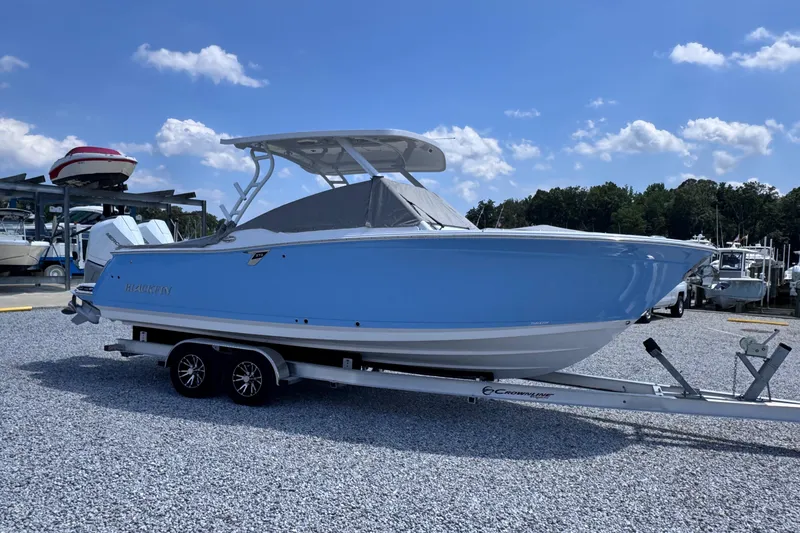 Slide: The Image of 2026 Blackfin 272 DC boat on trailer, parked outdoors under blue sky. - 9