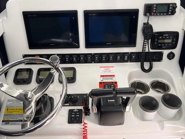 Slide: The Image of Control panel of 2015 Sea Hunt Gamefish 25 boat with steering wheel and electronic displays. - 9