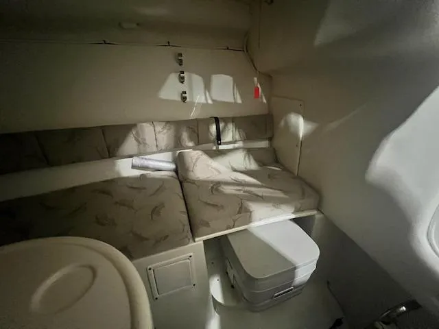 Slide: The Image of 2005 Hydra-Sports 2500 VX cabin interior with cushioned seating and compact storage. - 9