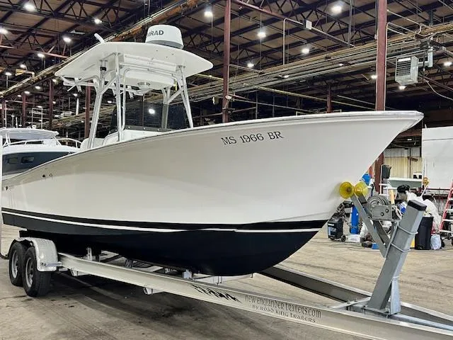 The Image of 1997 Silverhawk 24 CC boat on trailer in warehouse setting. - 0