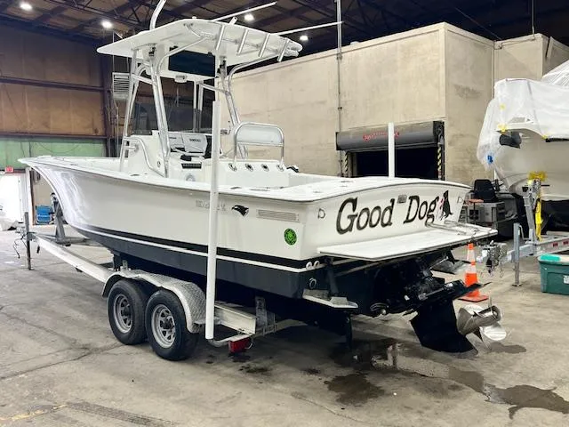Slide: The Image of 1997 Silverhawk 24 CC boat on trailer in warehouse, named "Good Dog." - 2