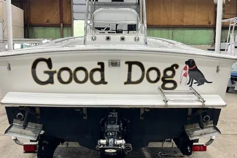 Slide: The Image of 1997 Silverhawk 24 CC boat named "Good Dog" with dog graphic on the stern. - 3