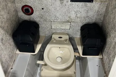 Slide: The Image of 1997 Silverhawk 24 CC boat interior with toilet and storage compartments. - 7