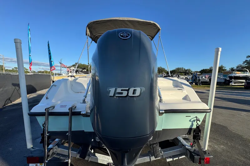 Slide: The Image of 2021 Key West 203 DFS boat with 150 horsepower engine, displayed outdoors. - 10
