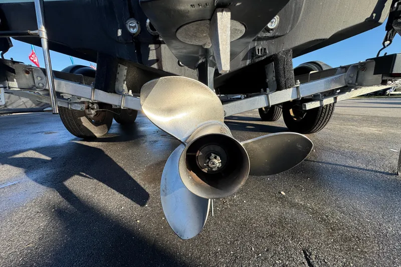 Slide: The Image of 2021 Key West 203 DFS boat with Yamaha outboard motor, parked under clear blue sky. - 12