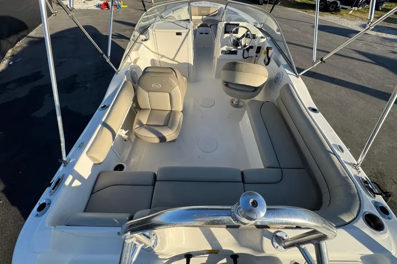 Slide: The Image of 2021 Key West 203 DFS boat interior with beige seating and steering console. - 14