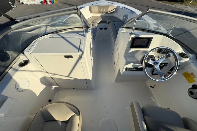 Slide: The Image of 2021 Key West 203 DFS boat interior with steering wheel and dashboard controls. - 20