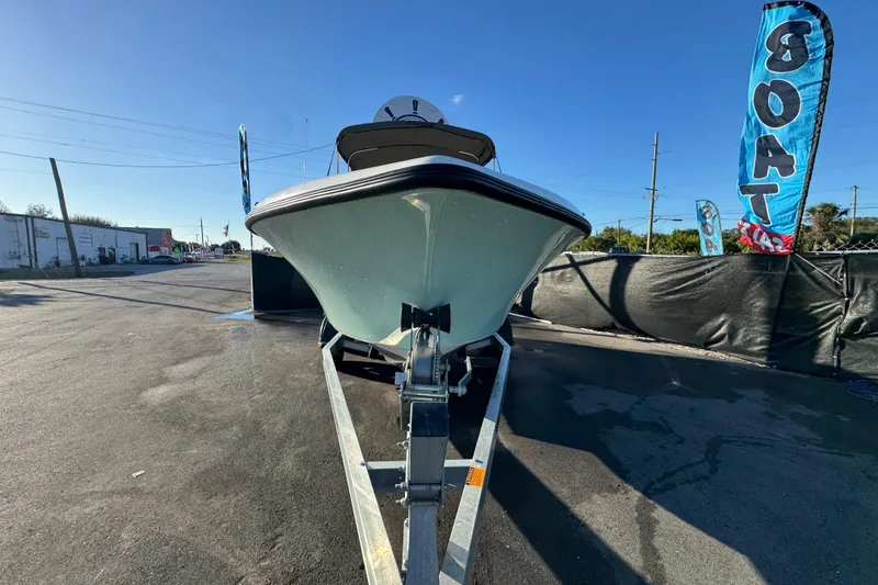Slide: The Image of 2021 Key West 203 DFS boat on trailer, displayed outdoors with blue sky backdrop. - 3