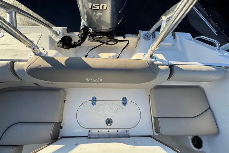 Slide: The Image of 2021 Key West 203 DFS boat interior with Yamaha 150 engine, featuring cushioned seating. - 50