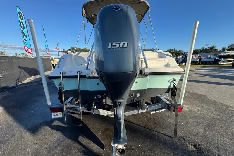 Slide: The Image of 2021 Key West 203 DFS boat with 150 HP engine, parked on a trailer. - 9