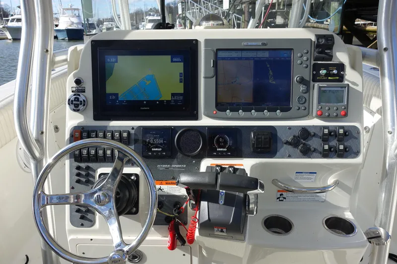 Slide: The Image of 2007 Hydra-Sports Vector 2900 CC boat docked at marina, featuring fishing rod holders. - 15