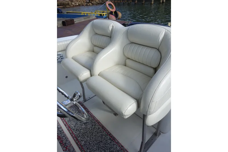 Slide: The Image of 2007 Hydra-Sports Vector 2900 CC boat with Evinrude 300 engines, featuring a cushioned seating area. - 4