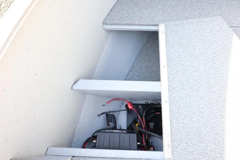 Slide: The Image of 2026 Lund 1600 Fury Tiller boat interior wiring and storage compartment. - 16