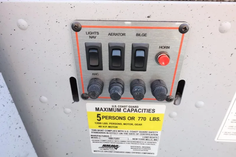 Slide: The Image of Control panel of 2026 Lund 1600 Fury Tiller boat with capacity label. - 19