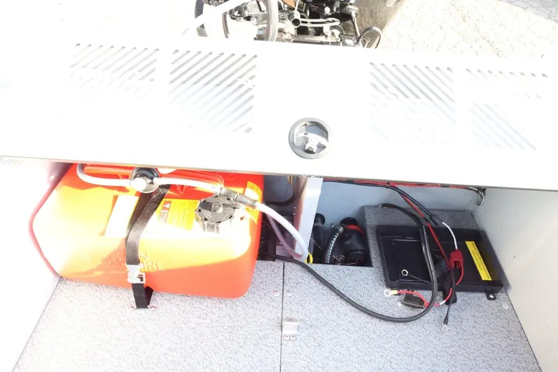 Slide: The Image of 2026 Lund 1600 Fury Tiller boat interior showing fuel tank and battery compartment. - 21