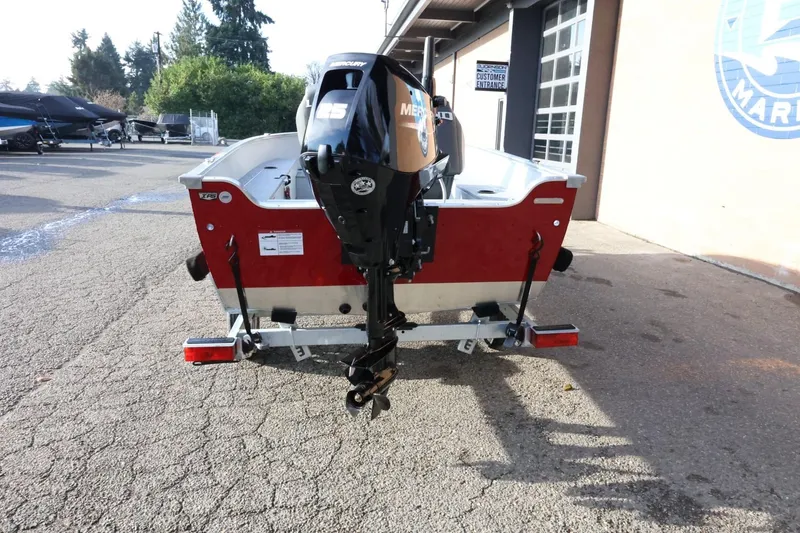 Slide: The Image of 2026 Lund 1600 Fury Tiller boat with Mercury engine, parked outdoors. - 8