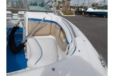 Slide: The Image of 2005 Four Winns 190 Horizon boat with white and blue interior, docked outdoors. - 11