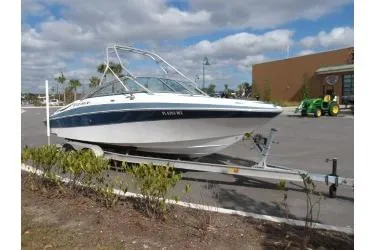 Slide: The Image of 2005 Four Winns 190 Horizon boat on trailer in parking lot. - 2